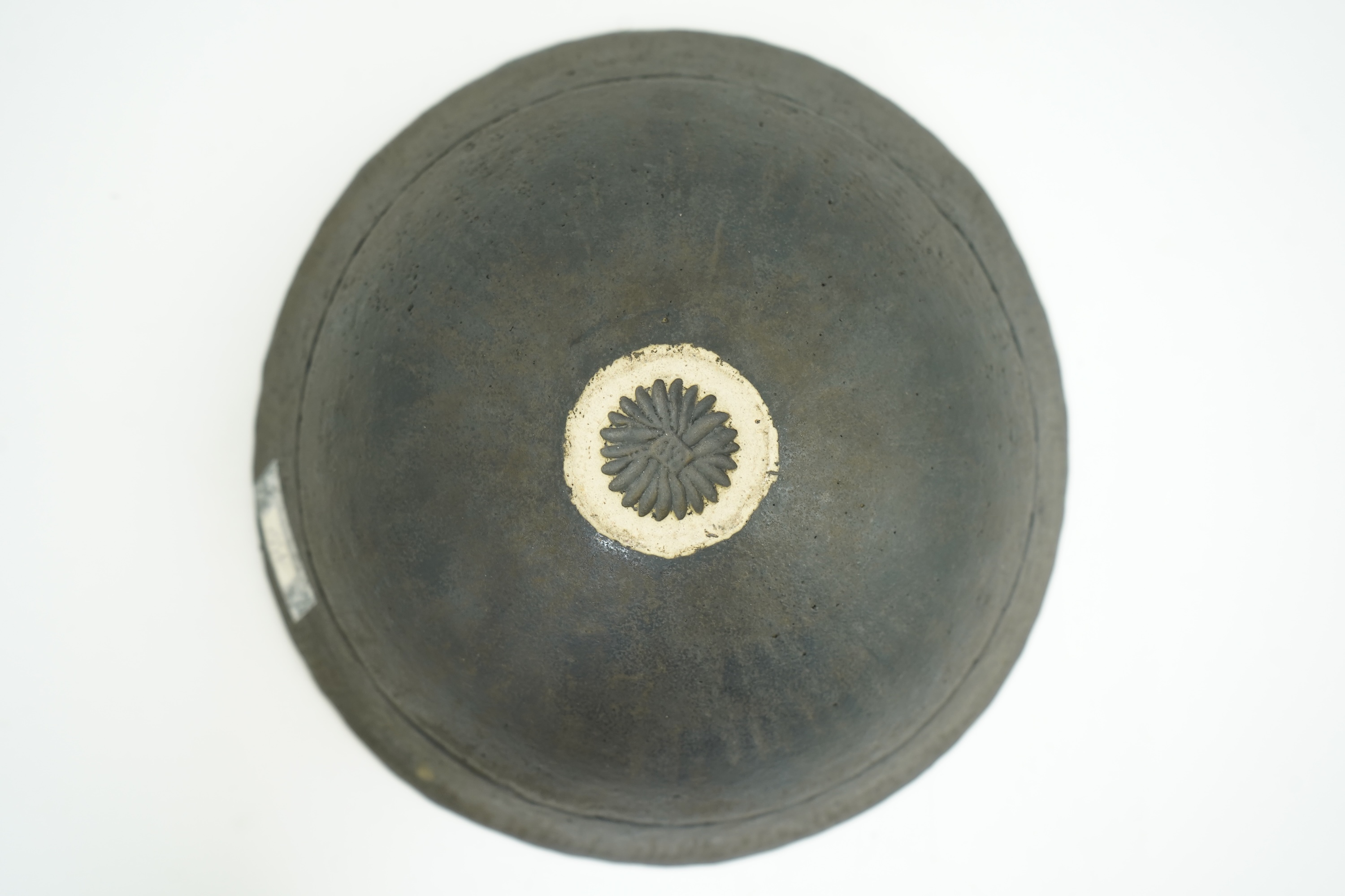 John Ward (1938-2023): A hand-built stoneware black glazed bowl with irregular rim